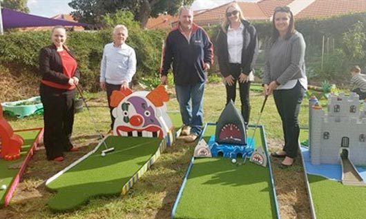 MatchWorks, Envision Employment Services and MAX Solutions team members with the Peninsula Sandtrap mini golf course.