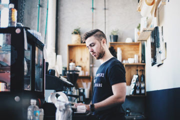 Man making coffee in a cafe