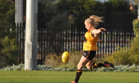 Trish Medwin on the field playing footy