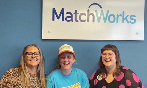 Tiahnee poses for camera in a blue t-shirt and white cap, standing in the centre between Holly from the MatchWorks Disability Employment Services team and her MatchWorks Employment Consultant Morgan standing to the right of picture.
